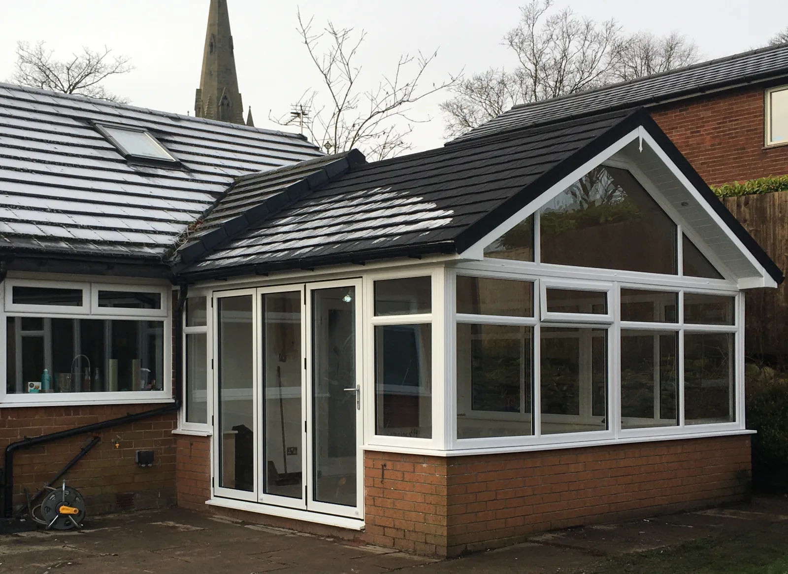 Supalite slate tiled conservatory roof in winter snow, demonstrating weather performance